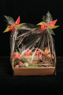 Basket richly filled with delicious home-made products with logo